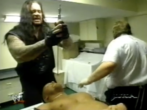The Undertaker holds up a long needle in an attempt to embalm Steve Austin alive on the Novermber 23rd edition of WWF Raw