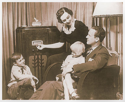 A family sits around the radio